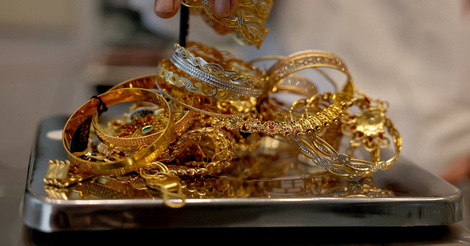 Gold retreats from record high as dollar strengthens ahead of key U.S. data